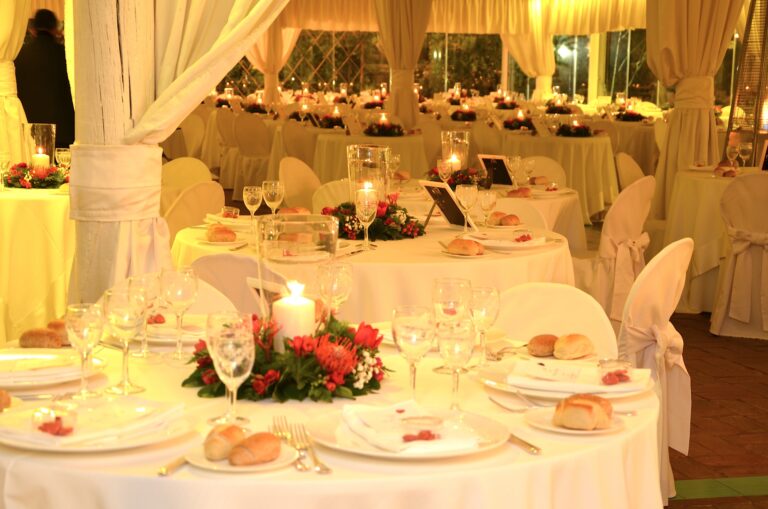 Candlelit round tables under draped white fabric for an evening dinner, Villa del Vecchio Pozzo in Posillipo