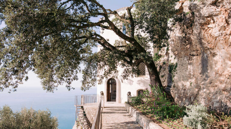 The path to the villa's entrance under an old oak, with the sea to the left, Villa La Rondinaia