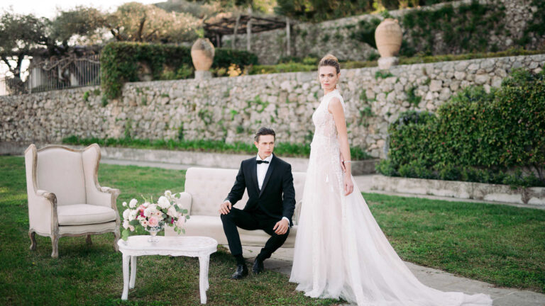A lawn on the garden terraces set with armchairs for a couple, Villa La Rondinaia