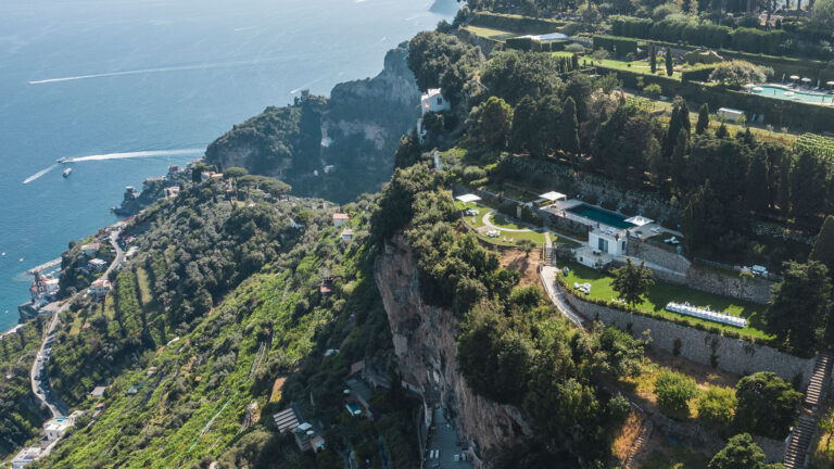 Aerial view of the terraced grounds and pool, with the coastline beyond, Villa La Rondinaia