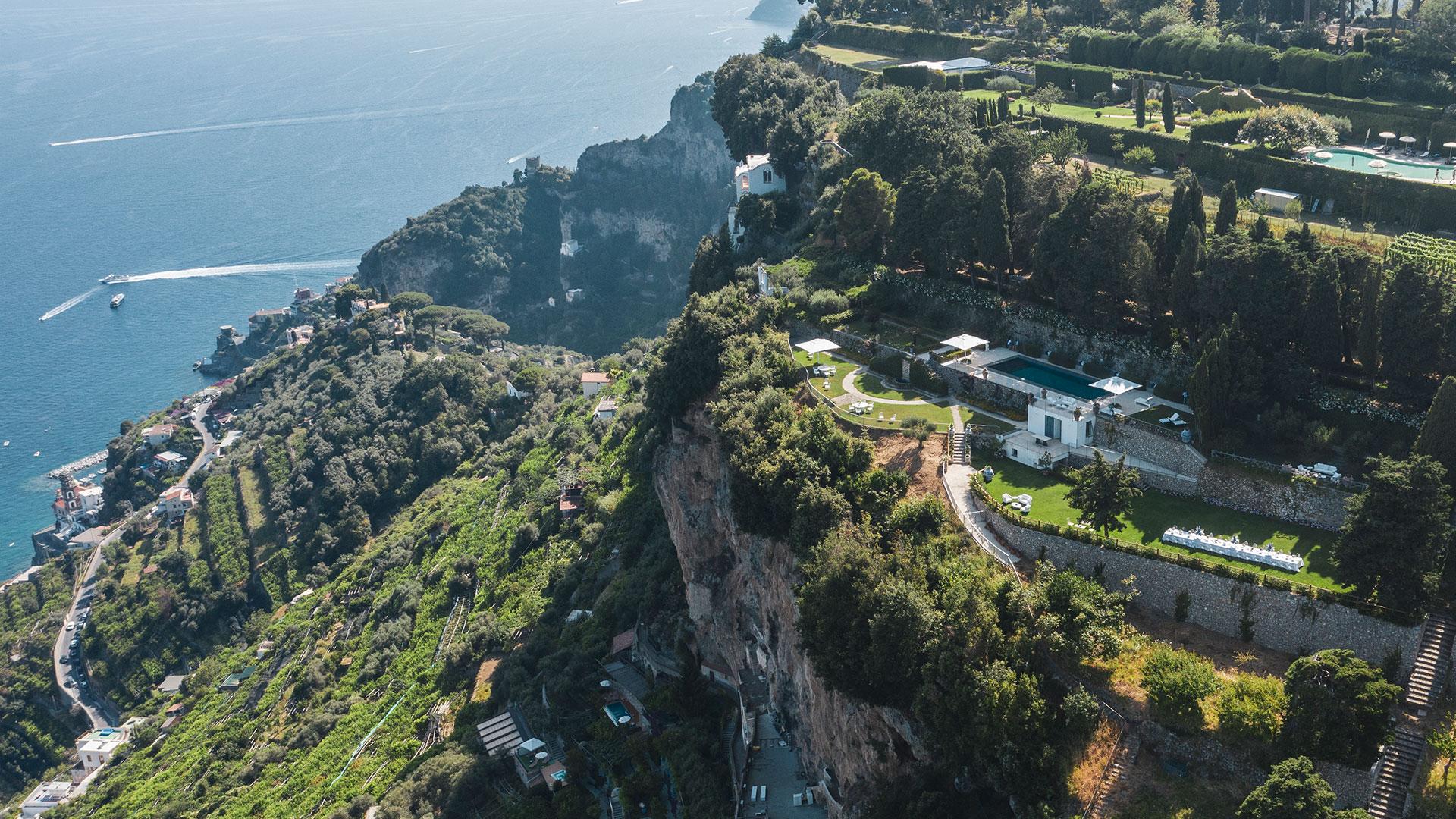 Aerial view of the terraced grounds and pool, with the coastline beyond, Villa La Rondinaia