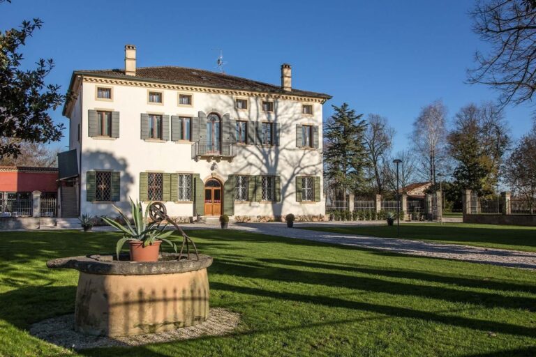 The villa from the side lawn, with an old stone wellhead planted with succulents in the foreground, Villa Ormaneto