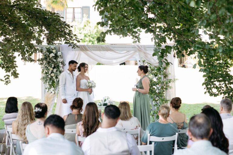 A ceremony in the garden, guests seated before a draped canopy, Villa Sofia