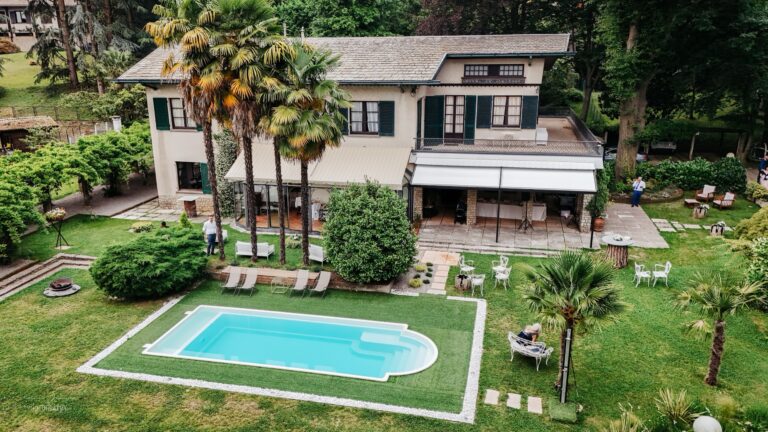 Aerial view of the villa, its palms and lawns, and the pool in the park, Villa Sofia