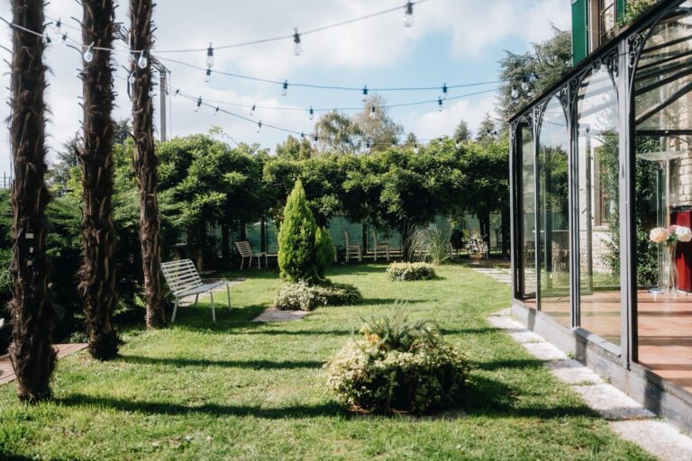 Lawn and festoon lights beside the glass veranda, Villa Sofia