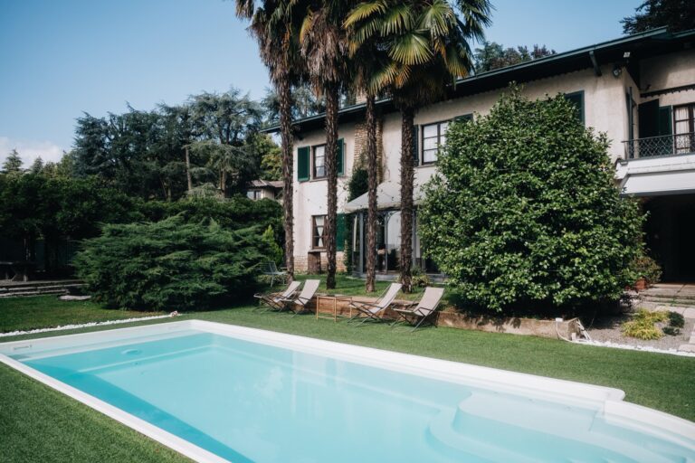 The pool on the lawn below the villa, with sun loungers along the edge, Villa Sofia