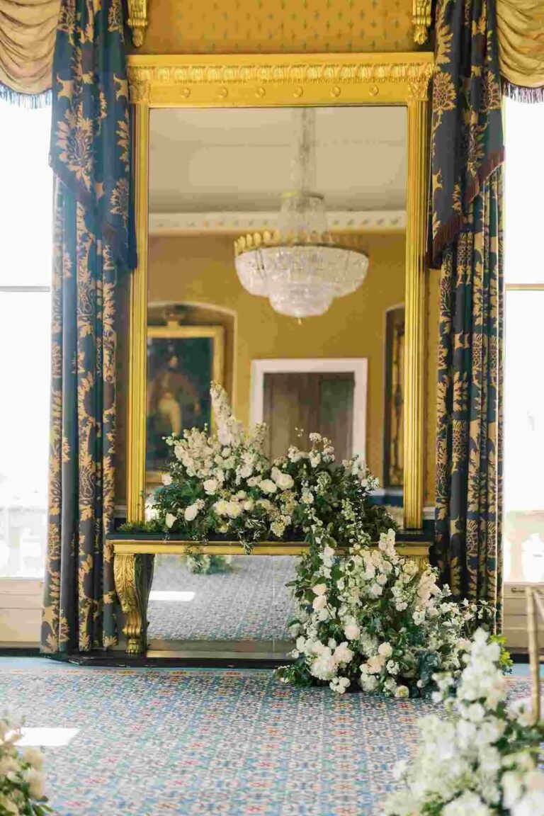 Ceremony florals framing the gilt pier glass, 116 Pall Mall