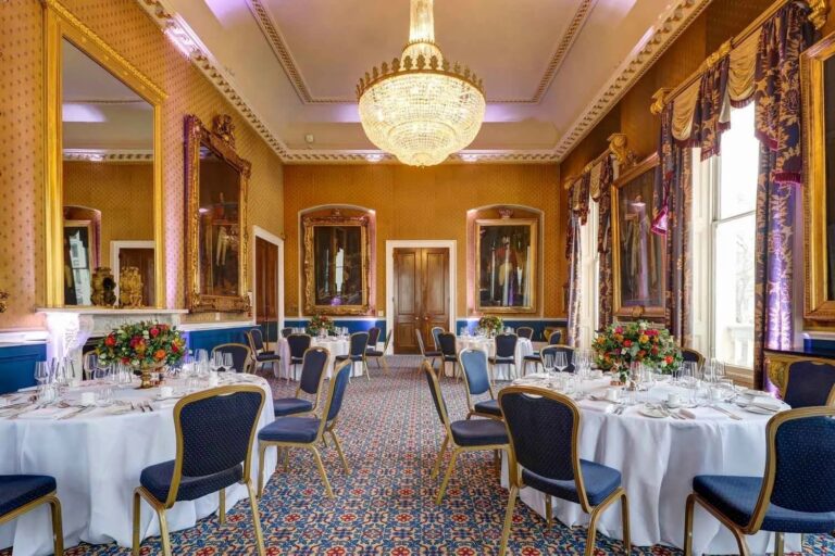The Waterloo laid for dinner, floor-to-ceiling Georgian windows over Pall Mall, 116 Pall Mall