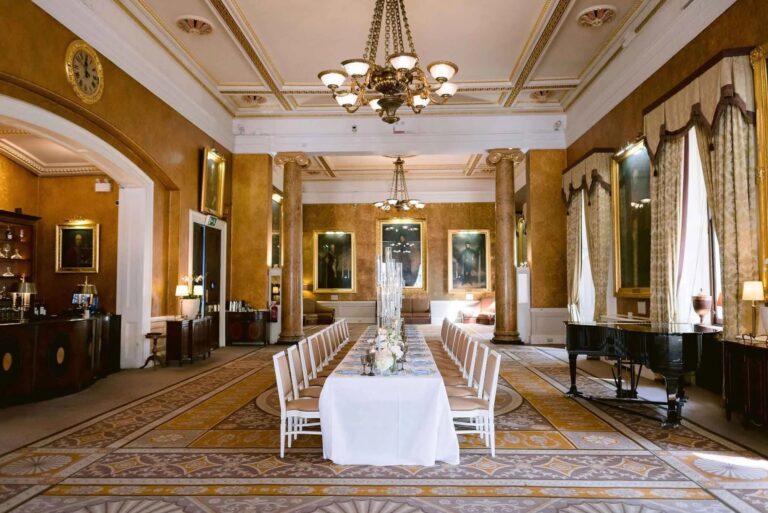The Carlton with a single long top table and the grand piano, 116 Pall Mall