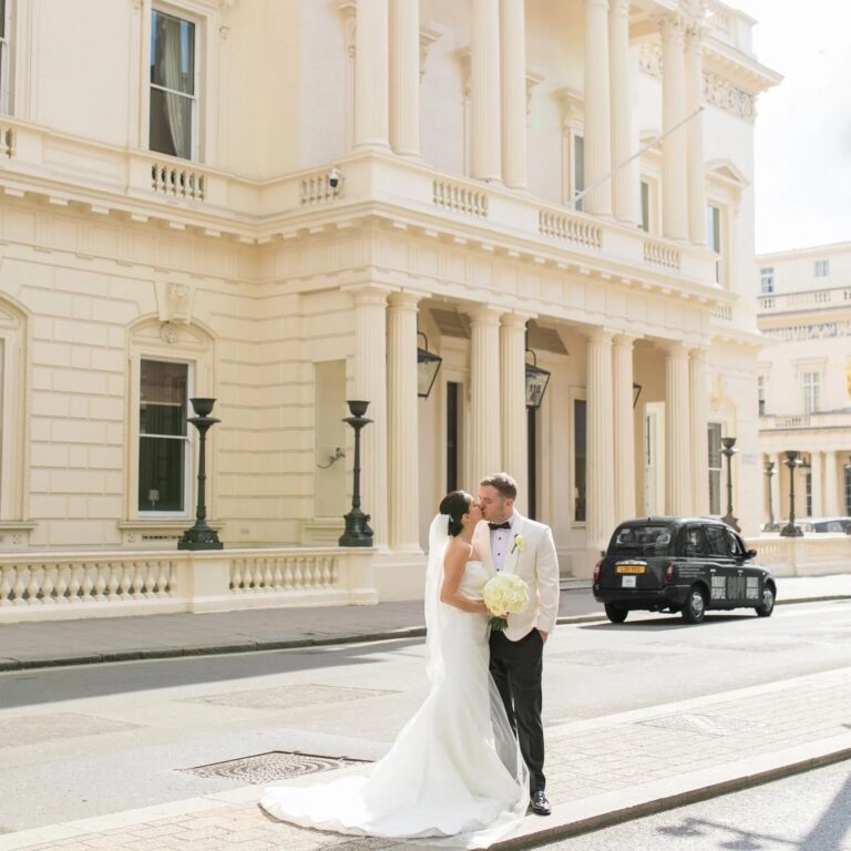 The couple outside 116 Pall Mall as a black cab passes, 116 Pall Mall