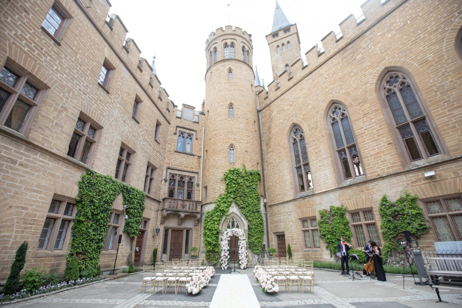 A ceremony set up on the aisle in the castle courtyard at a wedding in Germany
