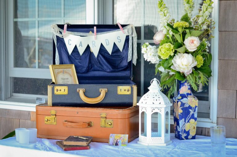 Vintage suitcases and lanterns styled as a welcome table at a Connecticut wedding, 5th Avenue Weddings