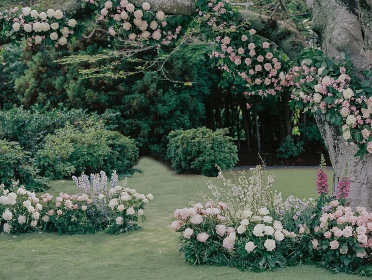Pink roses and delphiniums beneath an old tree in a Newport, Rhode Island garden, 5th Avenue Weddings