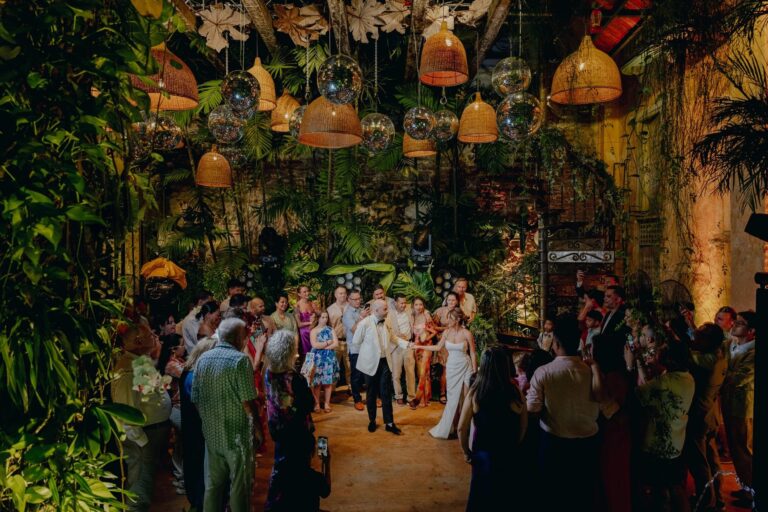 Courtyard reception under hanging lanterns and palms in Cartagena, 5th Avenue Weddings
