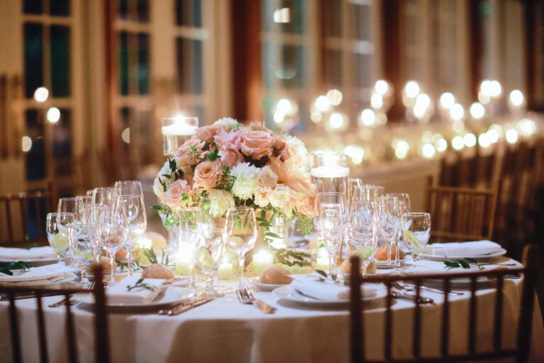 Rose centrepiece and glowing string lights at the Central Park Boathouse, 5th Avenue Weddings