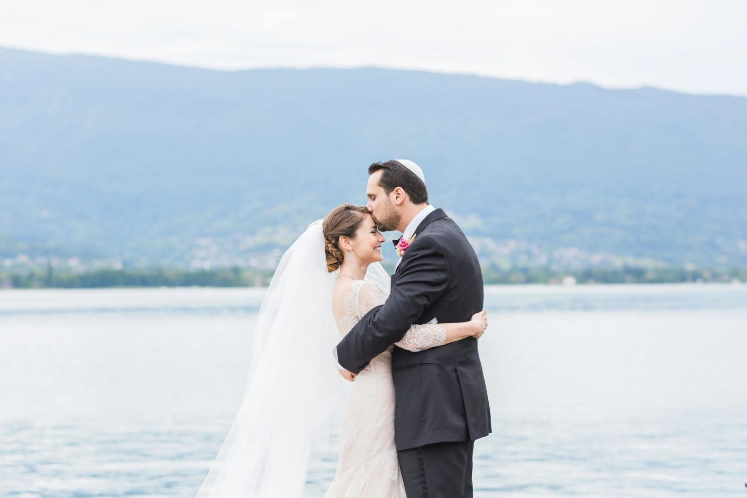 A couple on a lakeside pier at Lake Annecy, French Alps
