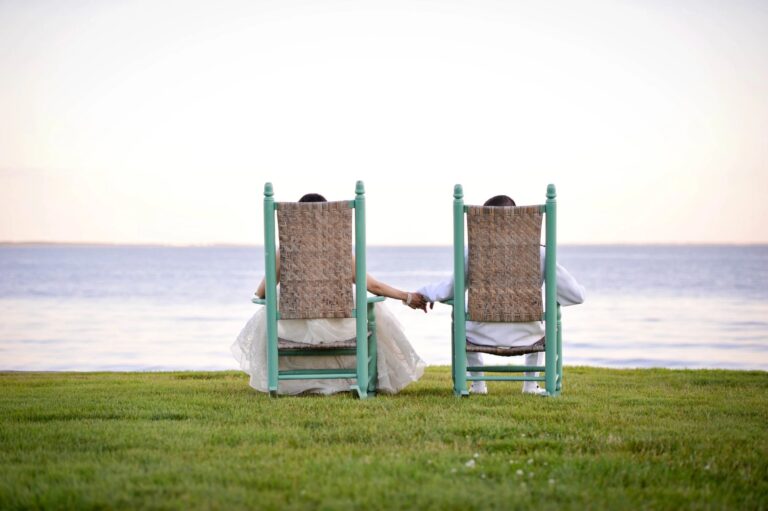 Two chairs facing the water on a lawn at a Connecticut waterside wedding, 5th Avenue Weddings