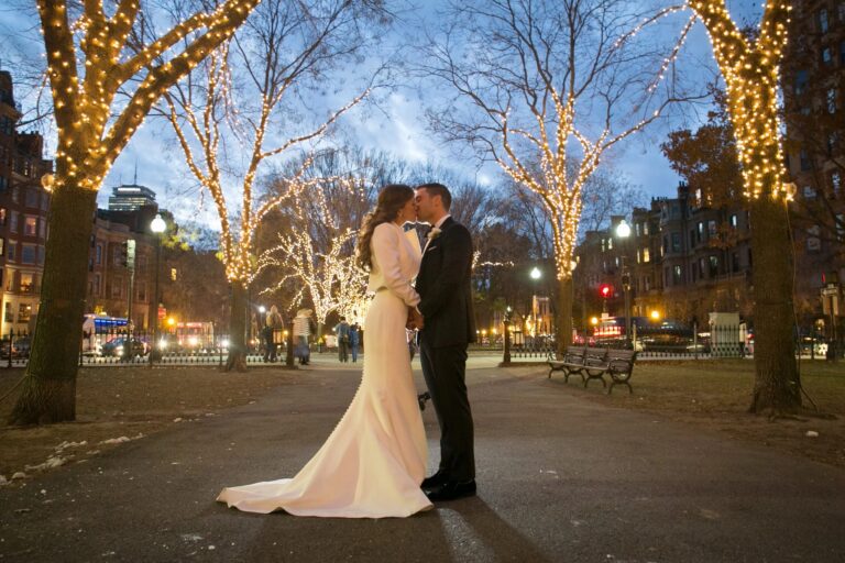 Couple beneath lit trees on a Boston street at night, 5th Avenue Weddings