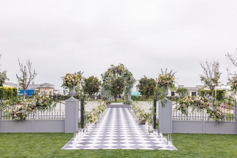 Checkered aisle between floral arrangements on a lawn ceremony site, About Details Details