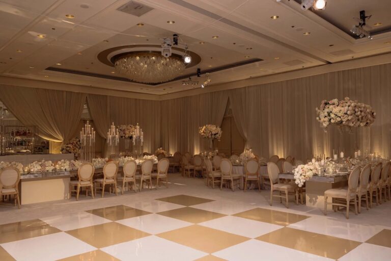 Hotel ballroom with gold chairs, chandeliers and tall floral centrepieces, About Details Details