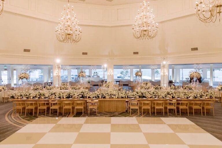 Banquet hall with chandeliers, a long head table and a checkered dance floor, About Details Details