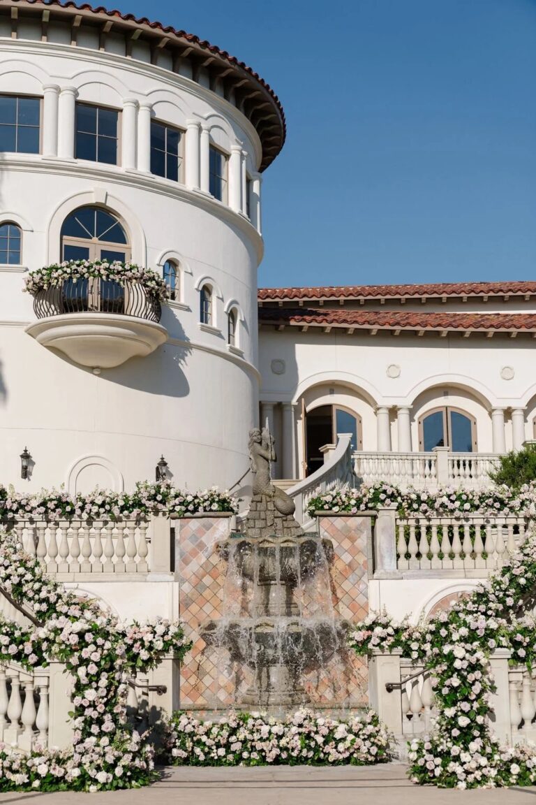 Courtyard fountain dressed with white floral garlands and arches, About Details Details