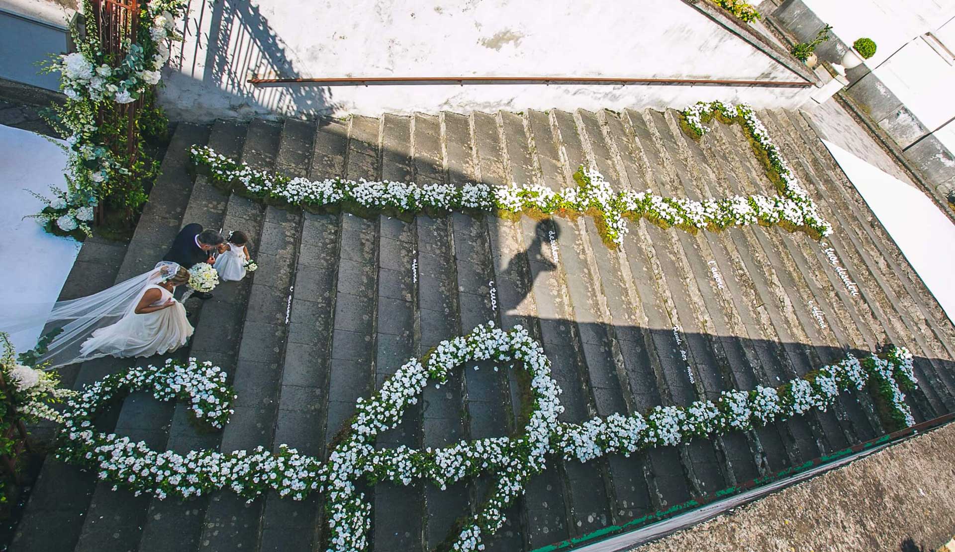 Church steps in the Amalfi Coast lined with floral garlands, seen from above, Alba Greco