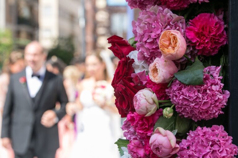 Red and fuchsia peonies and hydrangeas as the groom walks with guests, Alba Greco
