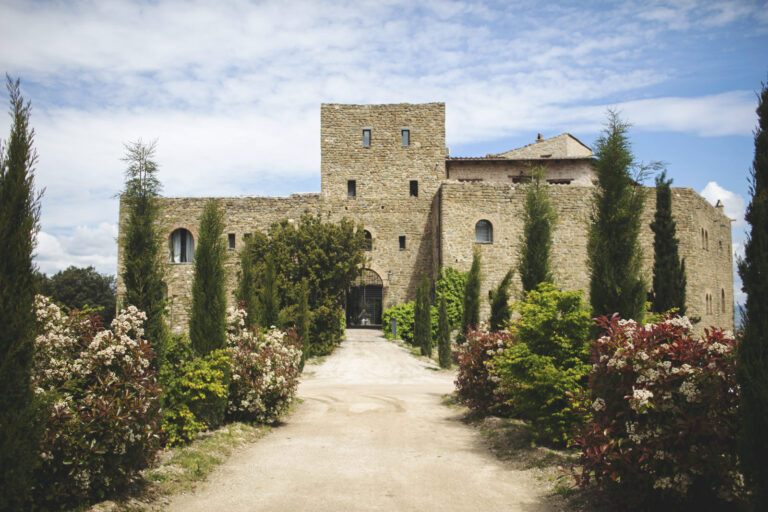 Stone castle at the end of a cypress-lined gravel drive, Alessandro Mari Photography