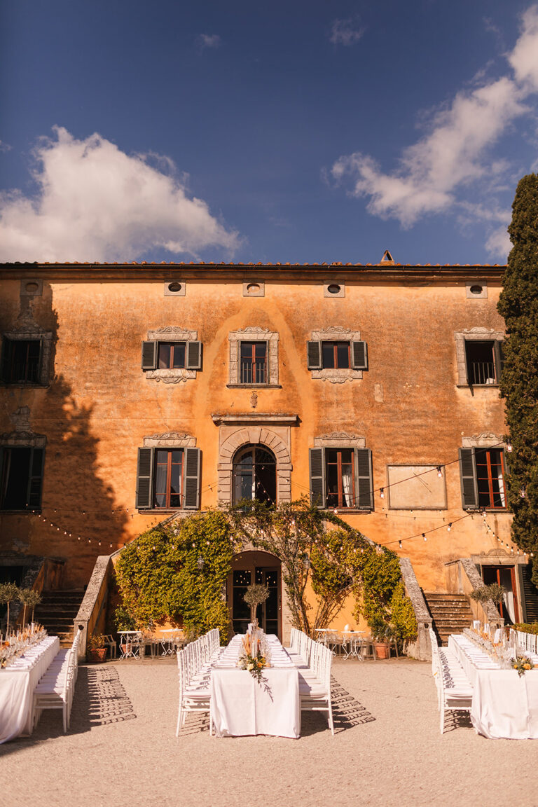 Ochre villa facade with the terrace dressed for a wedding lunch, Alessandro Mari Photography