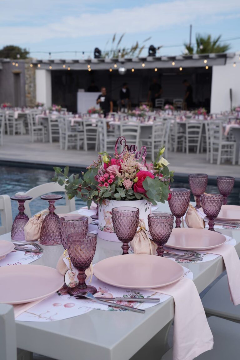 Pink and white table styling at a poolside reception