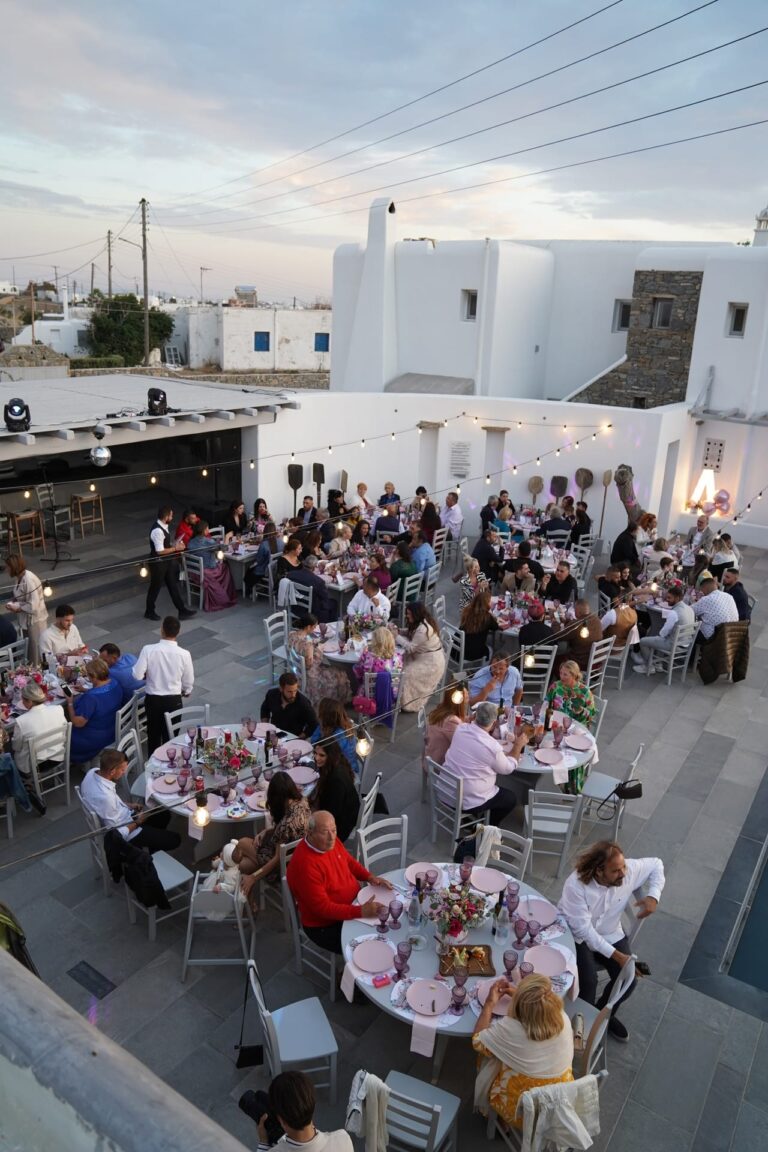Guests at a poolside wedding dinner