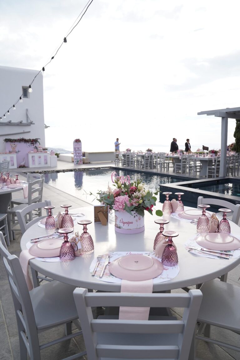 A round table laid for a poolside reception