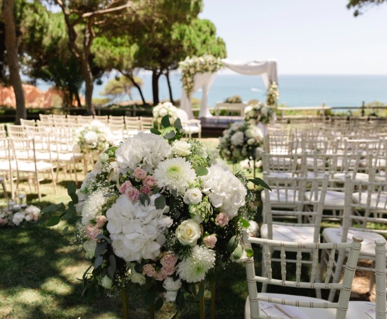 Ceremony chairs and arrangements on a clifftop lawn above the sea, Algarve Wedding Planners