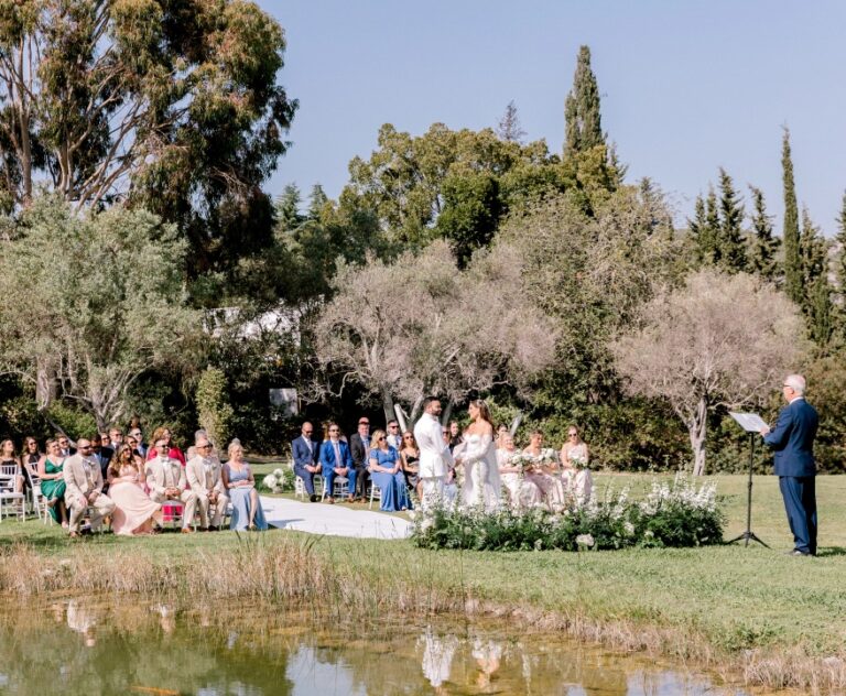 Outdoor ceremony on a garden lawn beside a pond, Algarve Wedding Planners