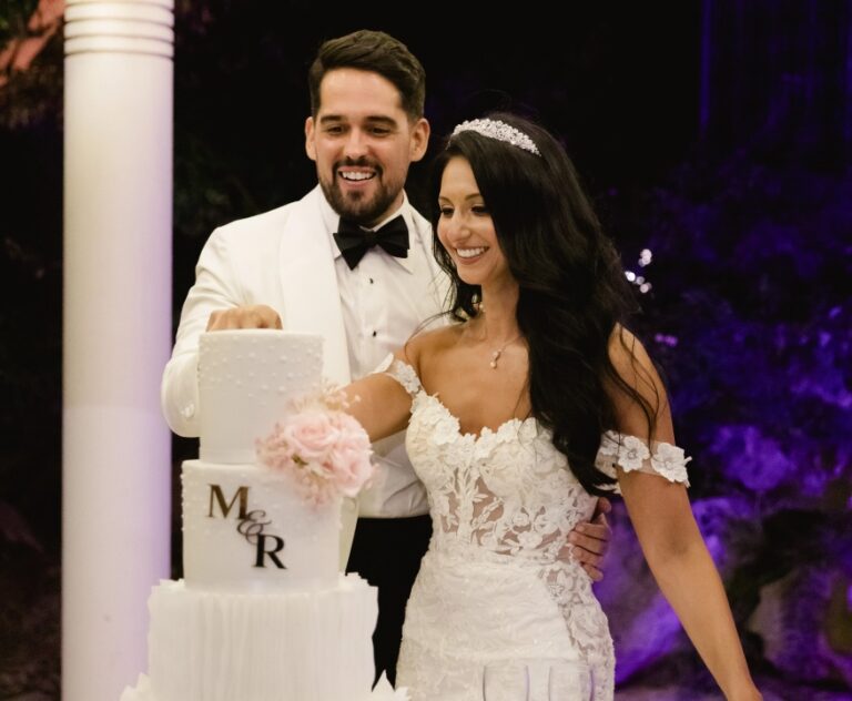 Couple cutting a monogrammed wedding cake in the evening, Algarve Wedding Planners
