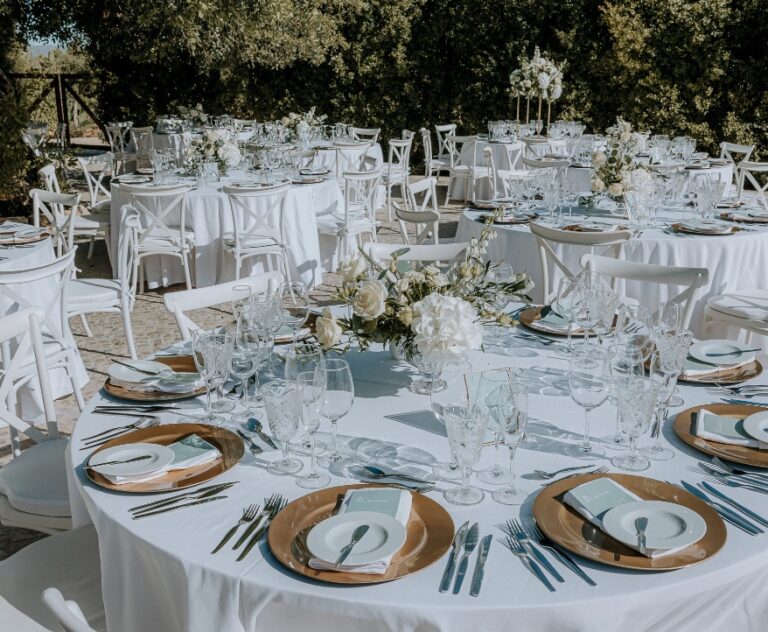 Round reception tables laid in an open-air setting, Algarve Wedding Planners