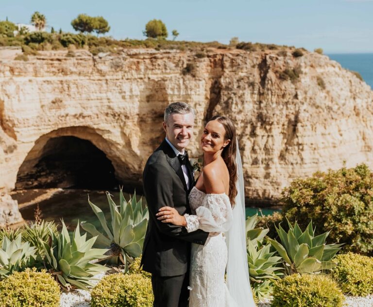 Couple on a clifftop with a sea cave behind, Algarve Wedding Planners