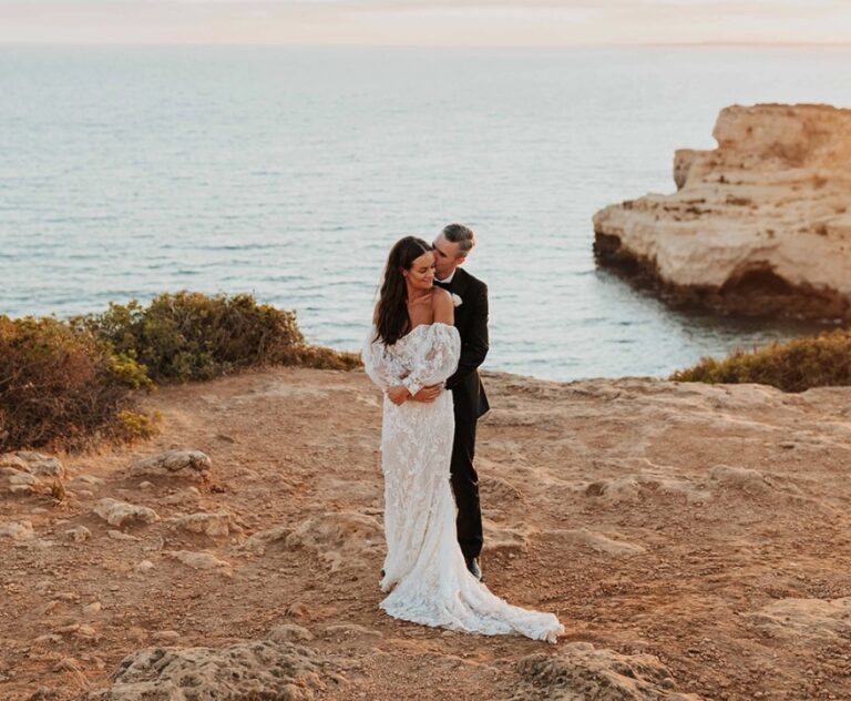 Couple embracing on a clifftop above the sea at sunset, Algarve Wedding Planners