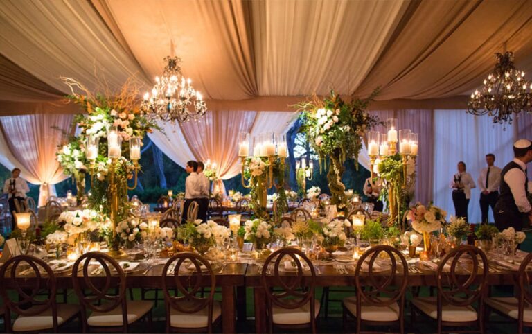 Tented reception with long tables, greenery and chandeliers, Aliana Events