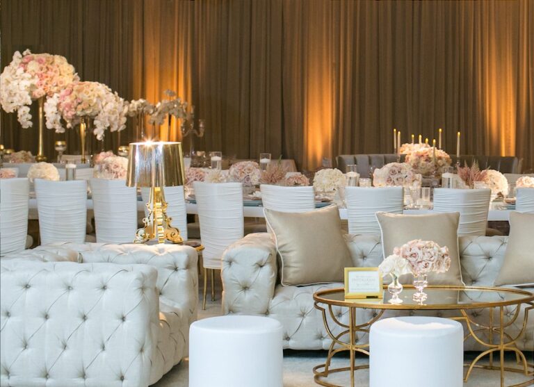 Lounge area with white tufted seating and gold tables in front of a bronze drape, Aliana Events