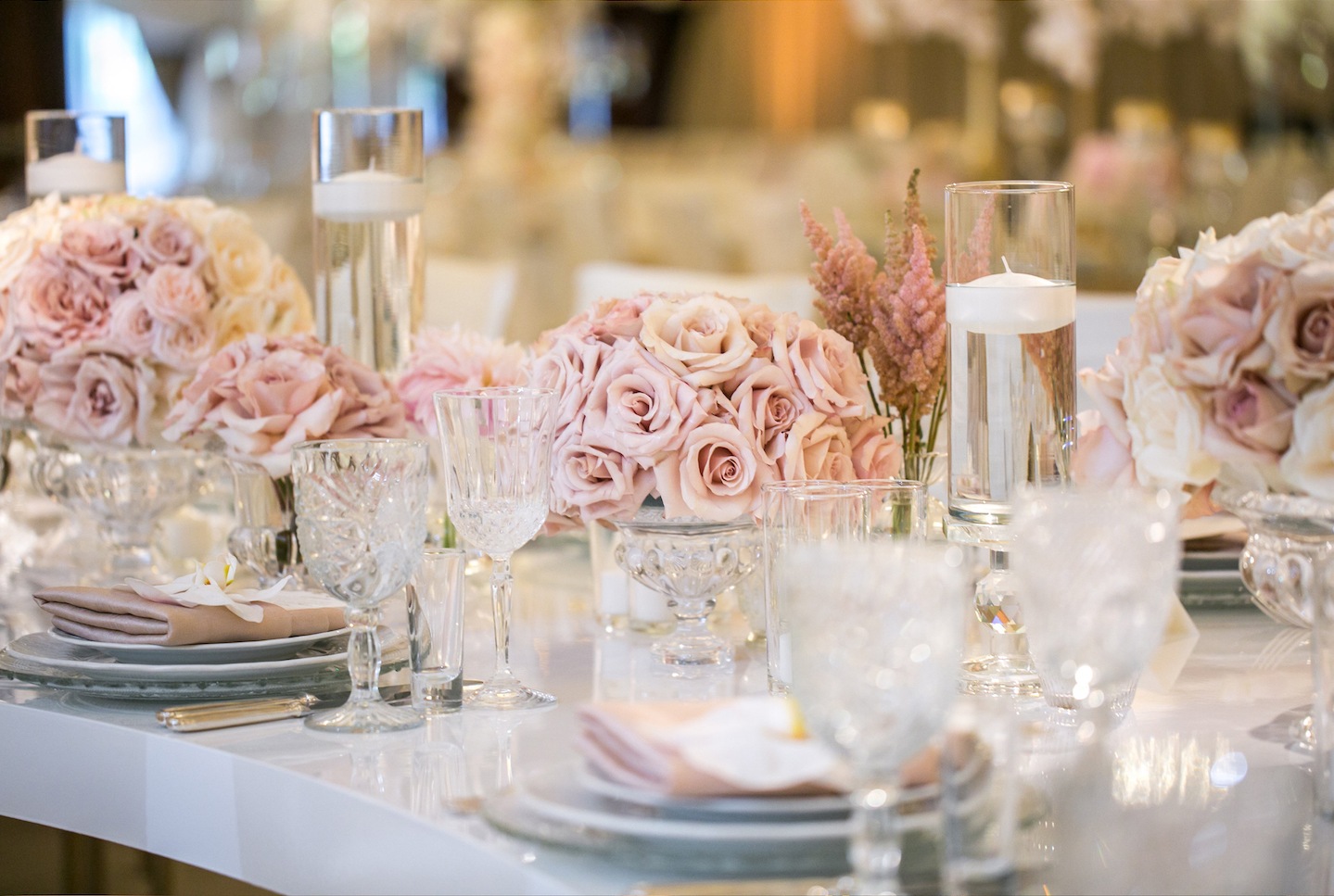Table set with blush roses, glass and candles, Aliana Events