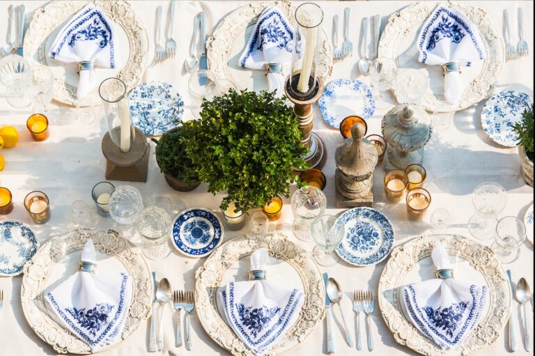 Table set with blue and white china, herbs and candles, Aliana Events