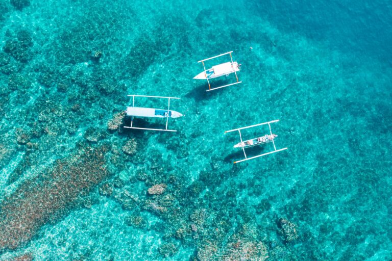 Jukung boats over the reef at the Blue Lagoon, Alila Manggis