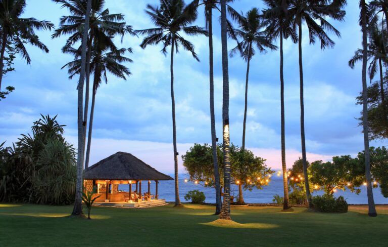 The Ocean Bar pavilion at dusk among the palms, Alila Manggis