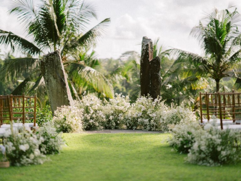 Wedding aisle with stone and flower arrangements, Alila Ubud