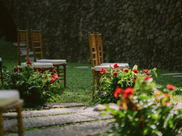 Wedding aisle with red flower arrangements, Alila Ubud