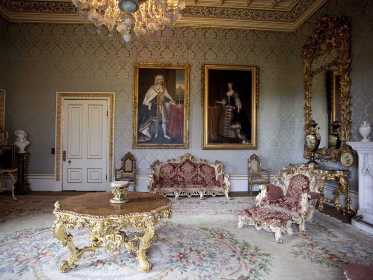 A gilded reception room hung with family portraits, gold-framed furniture and a chandelier, Allerton Castle