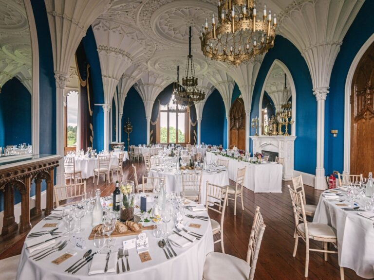 The Ballroom set with round tables for the wedding breakfast beneath the vaulted ceiling, Allerton Castle
