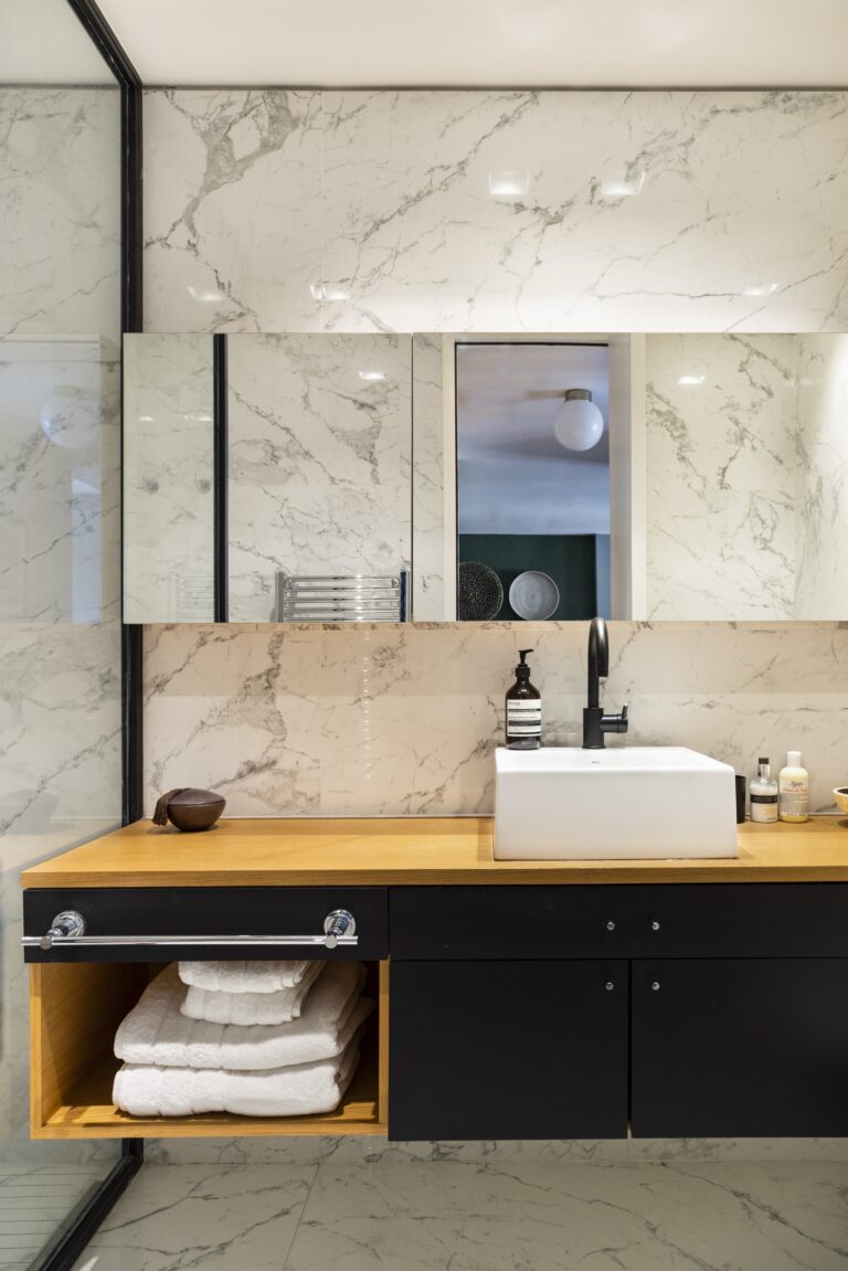 Bathroom with marble walls and a timber vanity, Alvear Design Guest House